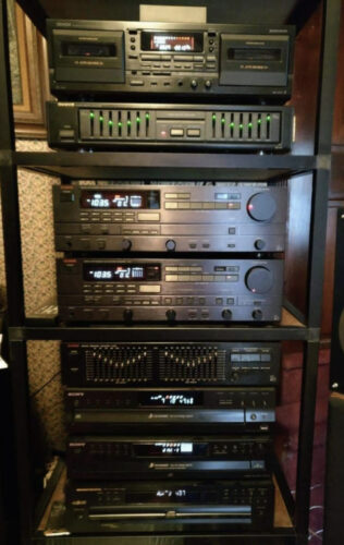 Stereo system rack built using EZTube, the global supplier of commercial and industrial framing, to store power amp, equalizer, CD player, cassette deck, integrated amp, and turntable