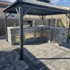 BBQ Grill Island, outdoor kitchen frame, BBQ island, barbecue pit, living area, outdoor BBQ pit, and building under construction using square tubes, metal tube, square tube connectors, 8020 tubes, t slot extrusions, linear rail tubes, 80 t slot connectors 20, 2020 eztubes, press fit connectors, ez tubes, faux stone panel, stone, concrete, stone wall, and metal framing